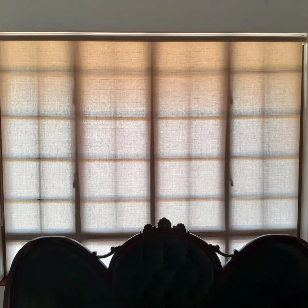 Sunscreen roller blind in a dining room with antique upholstered chairs