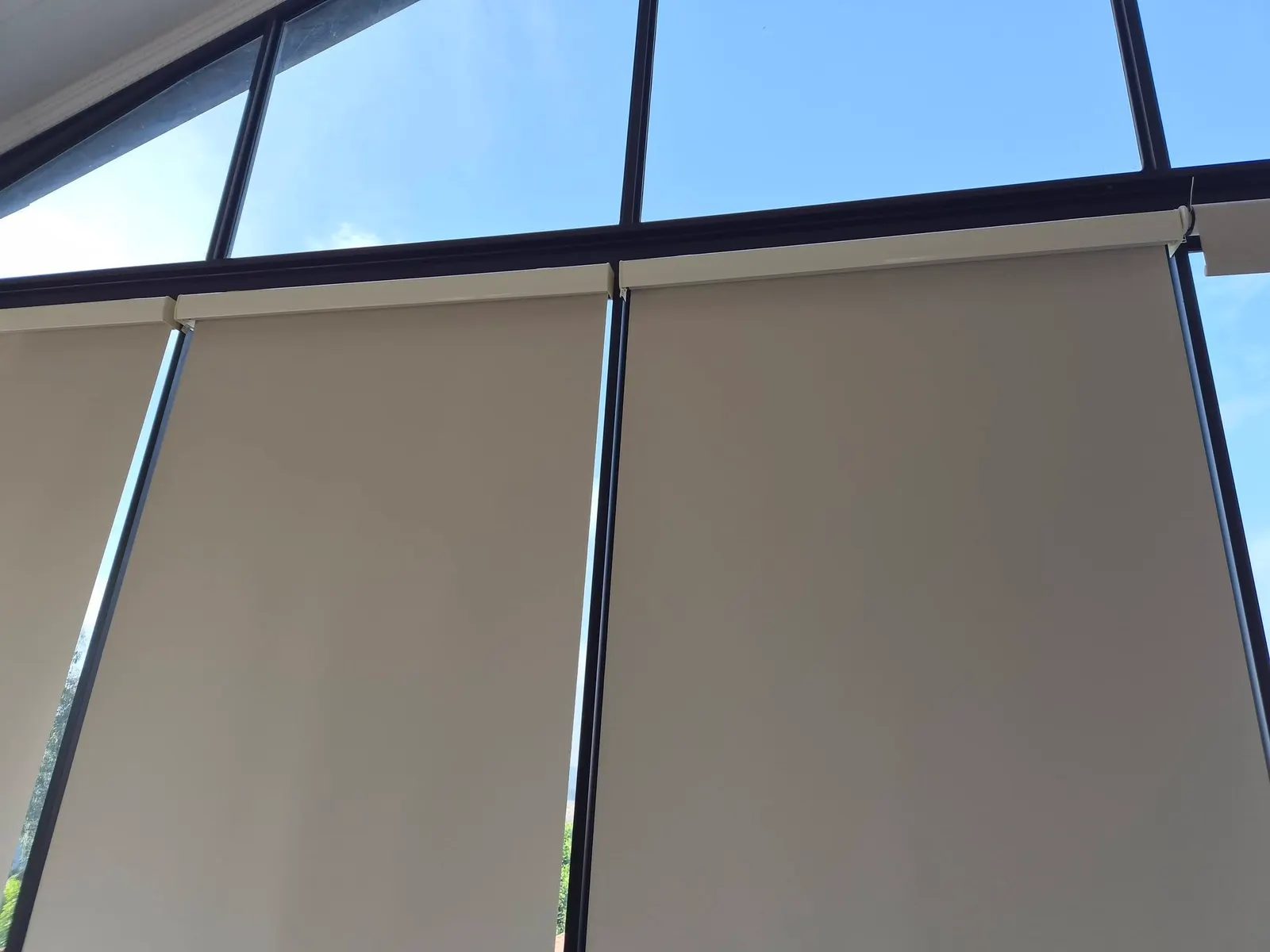 Close-up of neutral sunscreen roller blind fabric and cassette housing