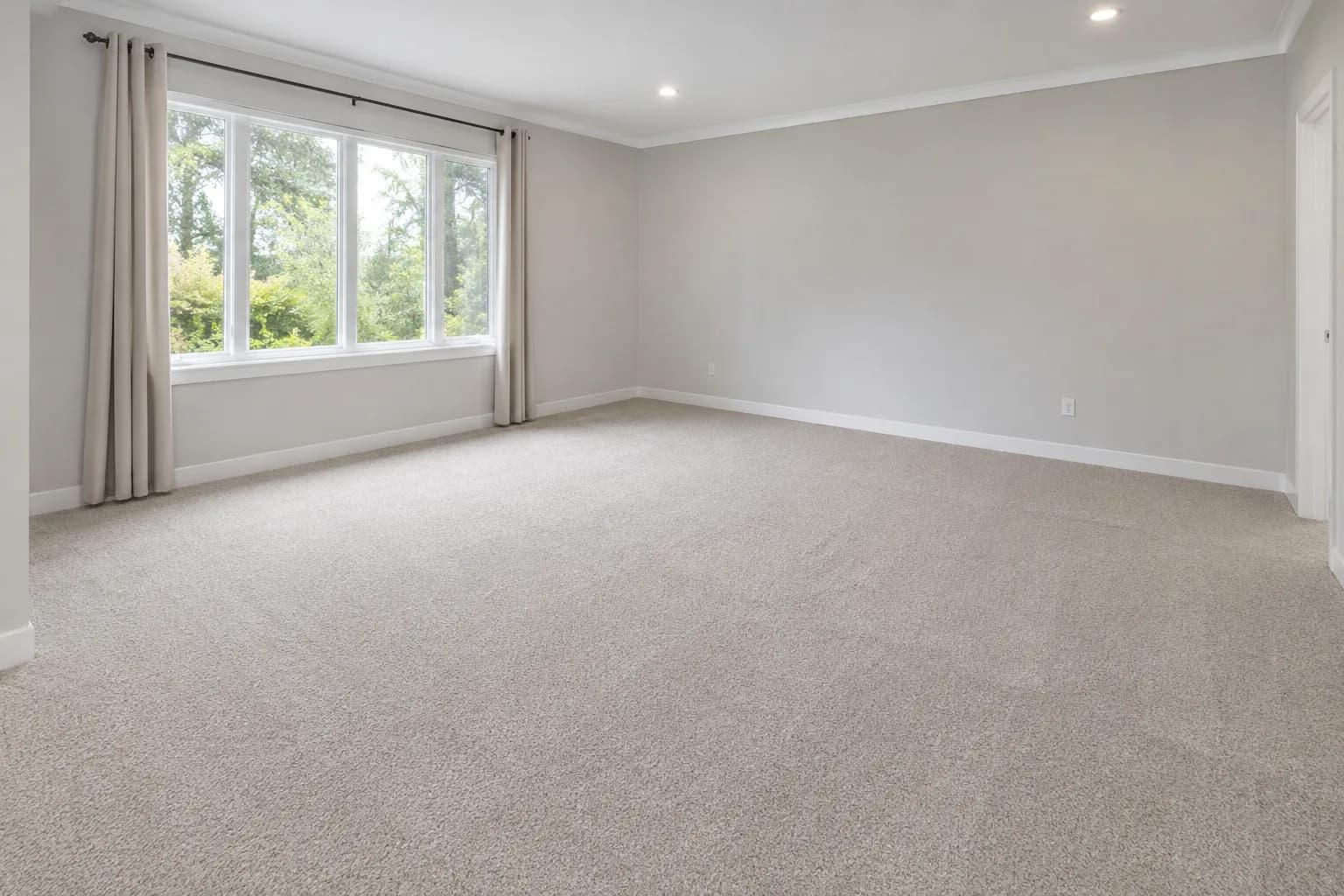 Wall-to-wall carpet in a bright bedroom